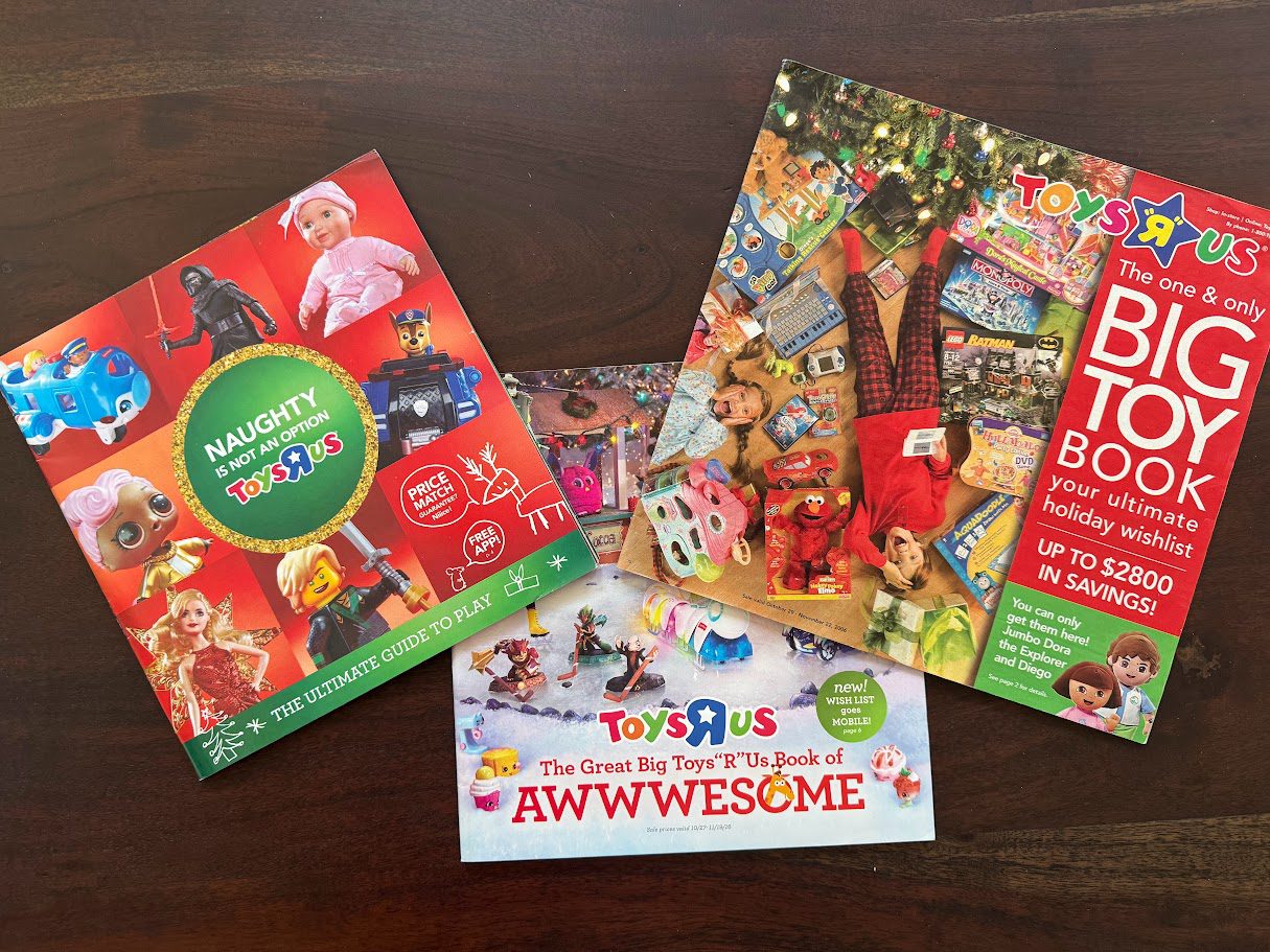 A stack of old Toys R Us holiday catalogs