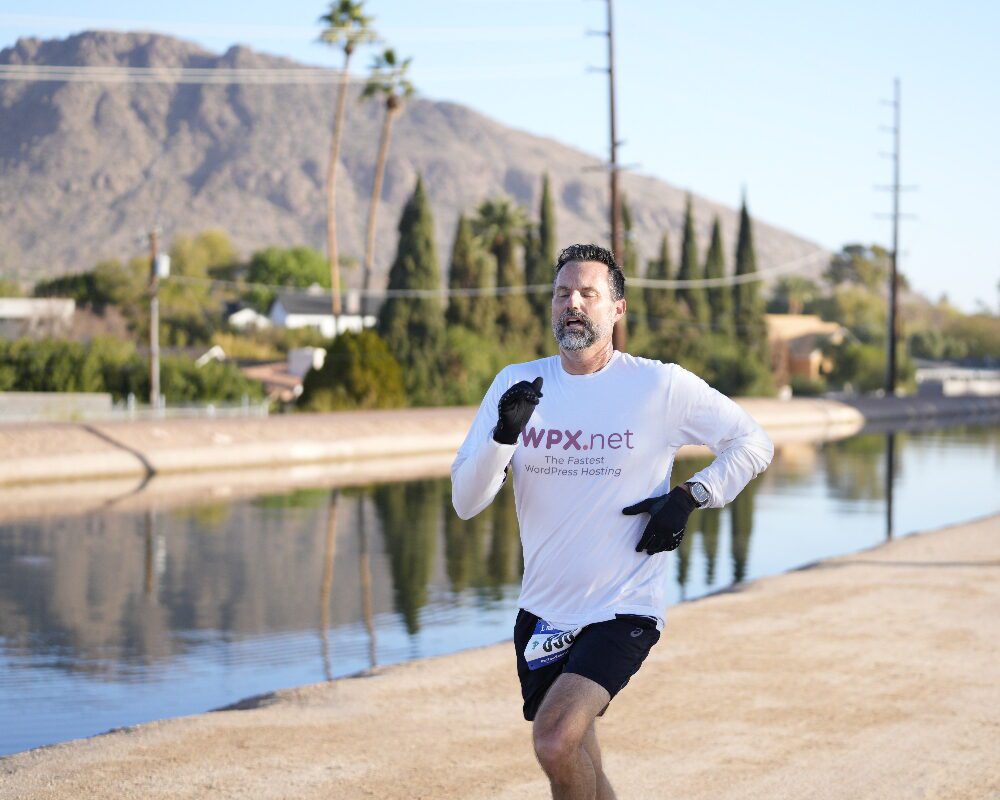 Patrick running along a canal path in Phoenix